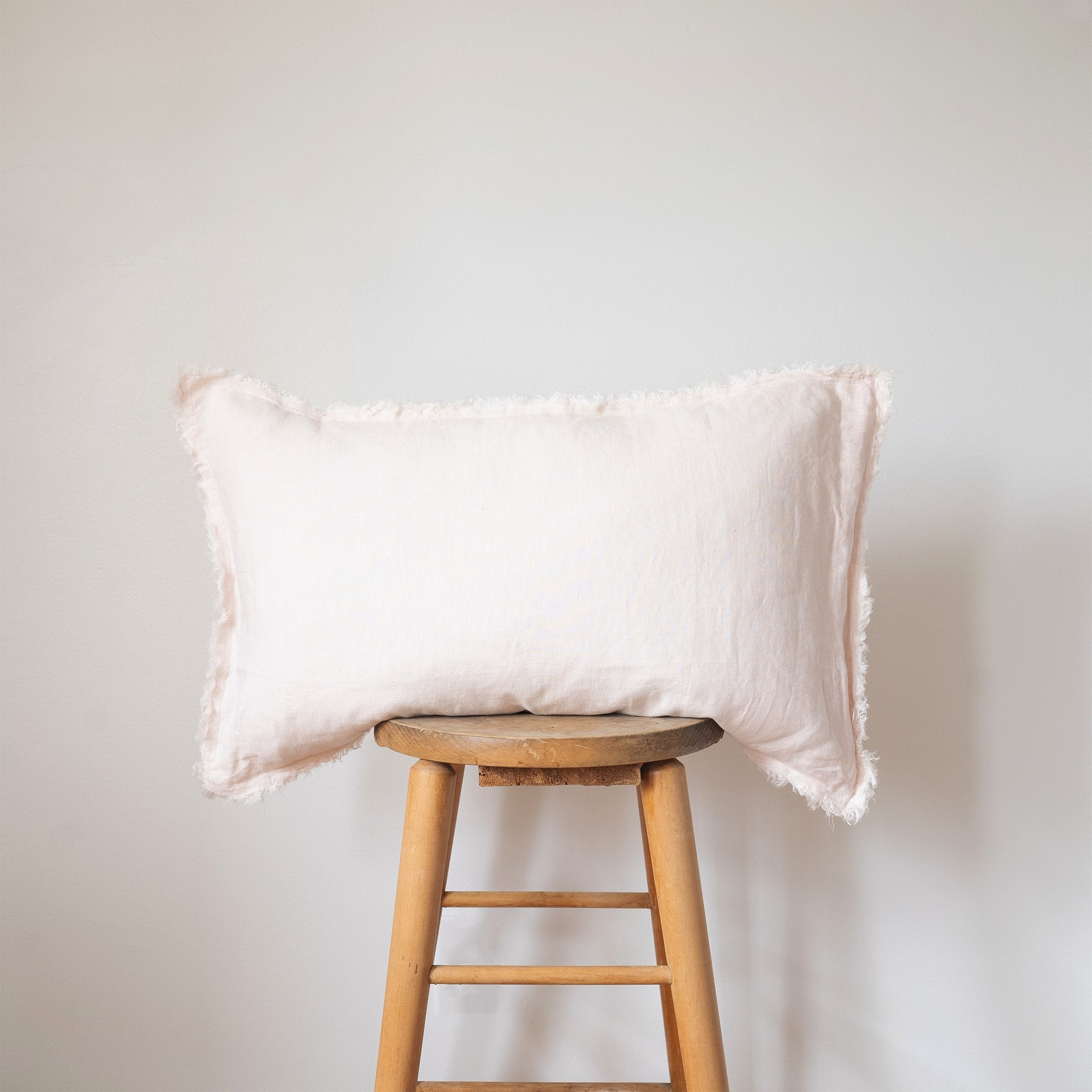 fringed blush linen lumbar pillow 